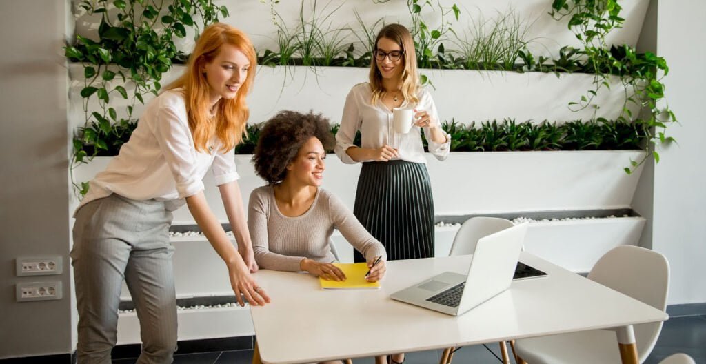 A group of women employees working together in a collaborative environment.