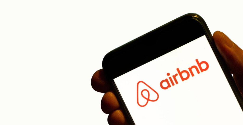 Brand logo of Airbnb displayed on a smartphone screen